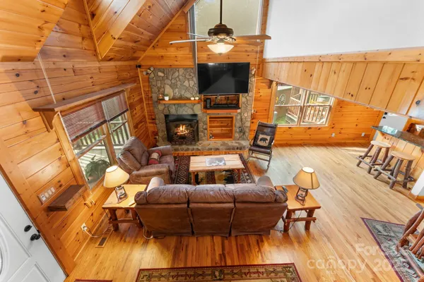 a view of a balcony with chairs and wooden floor