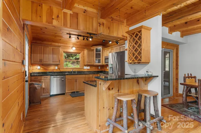 a kitchen with stainless steel appliances granite countertop a stove and cabinets