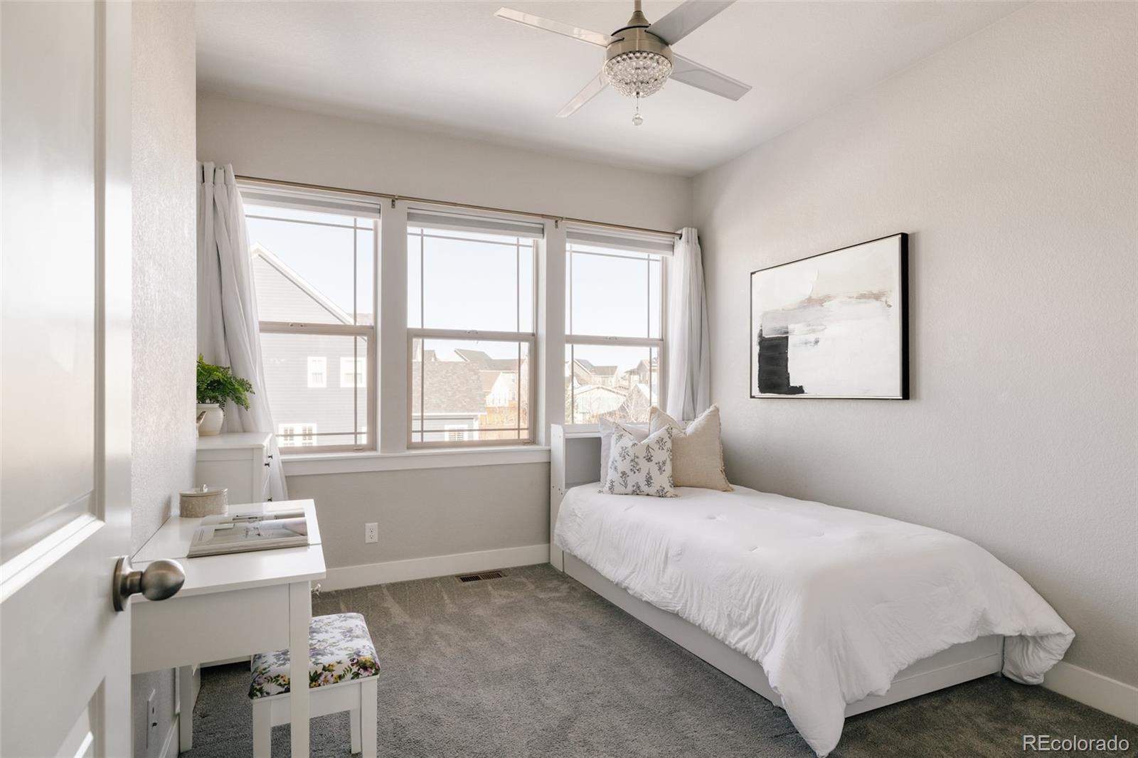 5191 Willow Way Denver, CO 80238 - Photo 19 of 36 a bedroom with a bed and a window