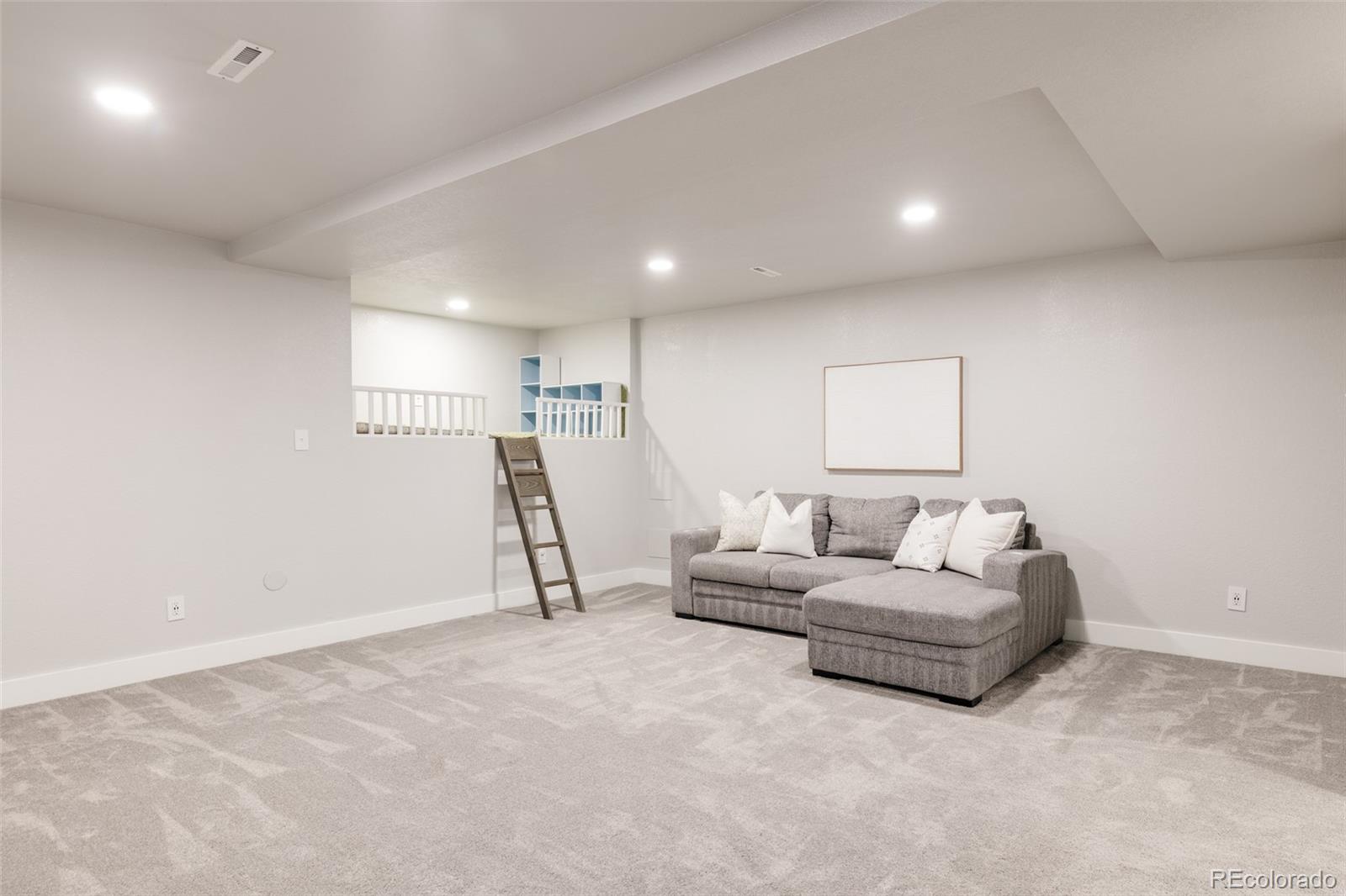 5191 Willow Way Denver, CO 80238 - Photo 23 of 36 a living room with furniture and white walls