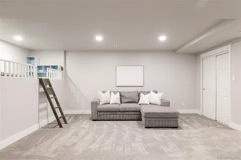 a living room with furniture and a open to kitchen