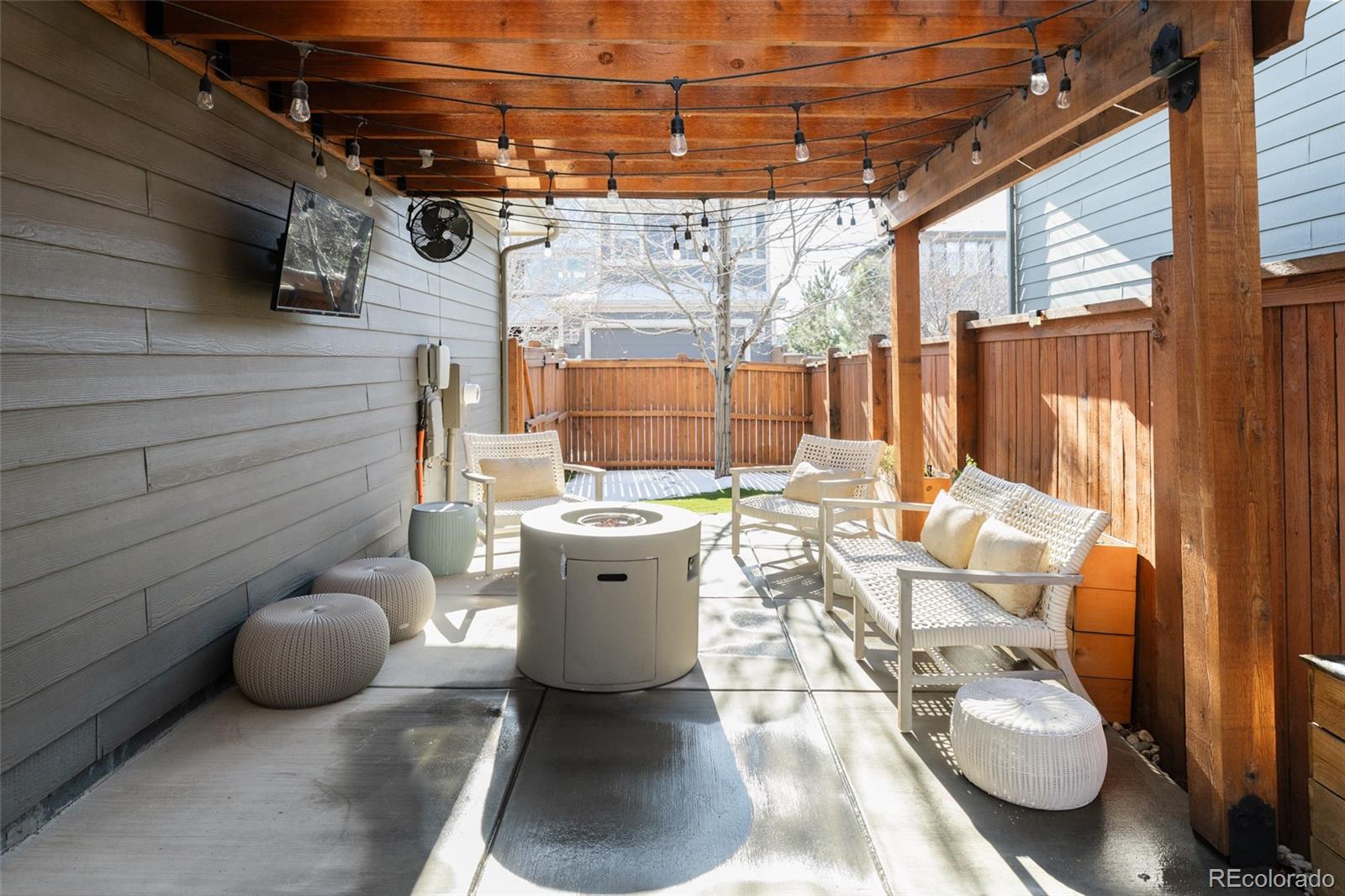 5191 Willow Way Denver, CO 80238 - Photo 29 of 36 a view of a patio with table and chairs couches with wooden floor and fence