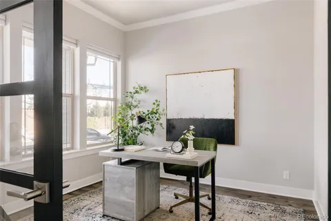 a view of a dining room with a table and chairs