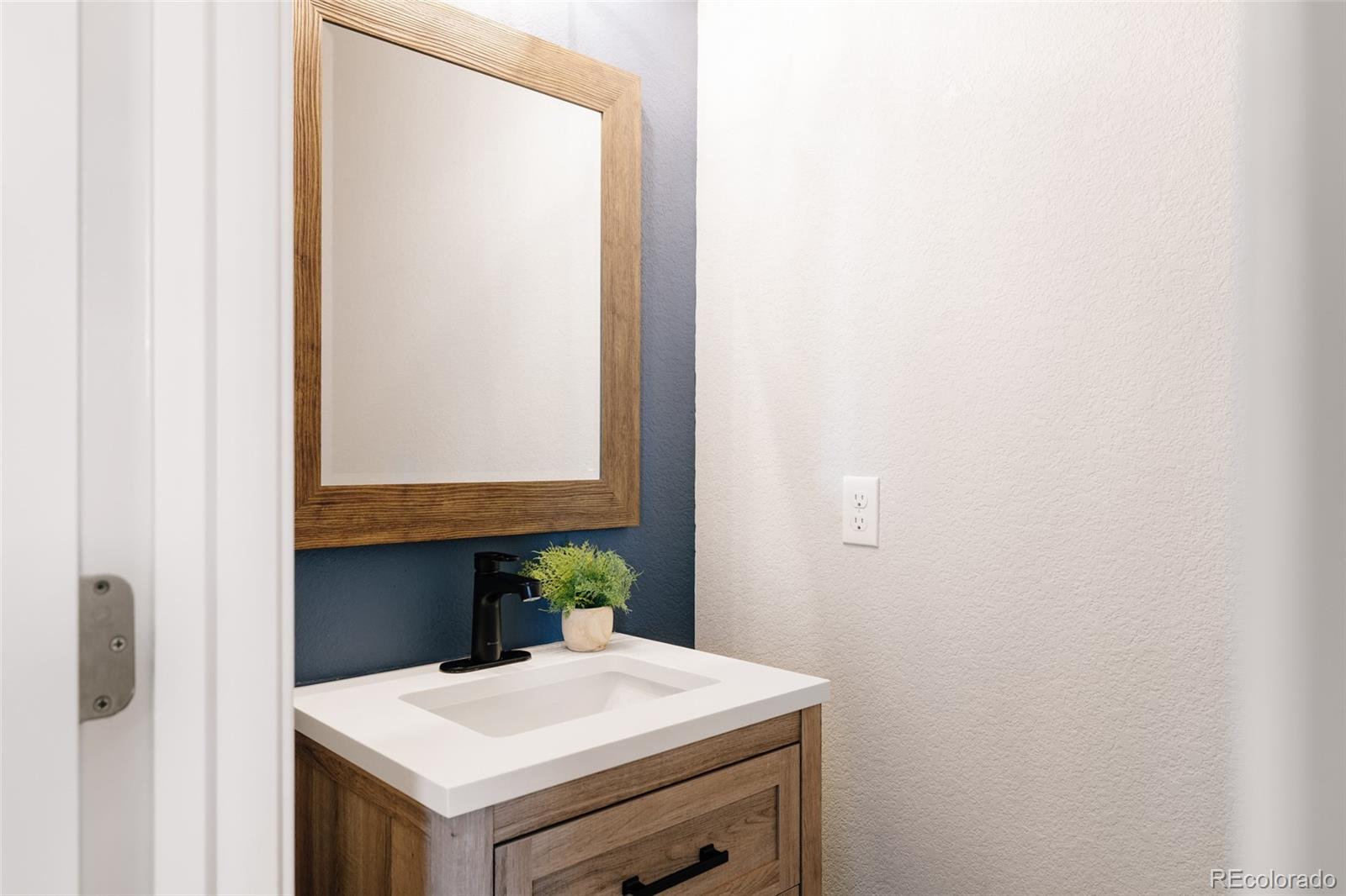 5191 Willow Way Denver, CO 80238 - Photo 10 of 36 a room with a wooden floor and white wall