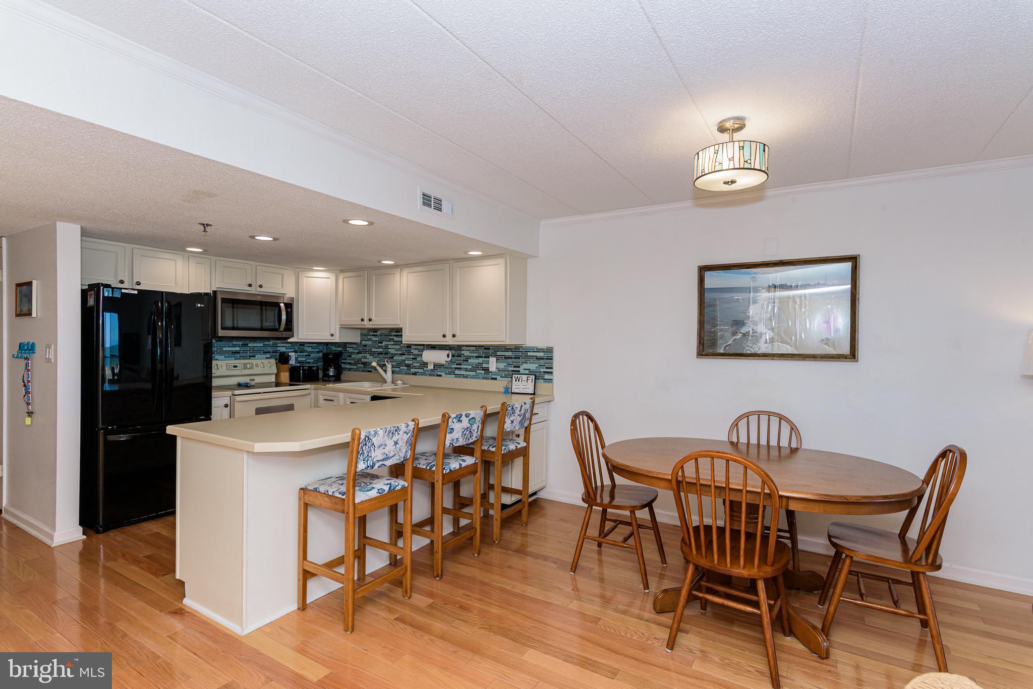 5 77th Street, Unit 102 Ocean City, MD 21842 - Photo 12 of 38 a view of kitchen with dining table and chairs