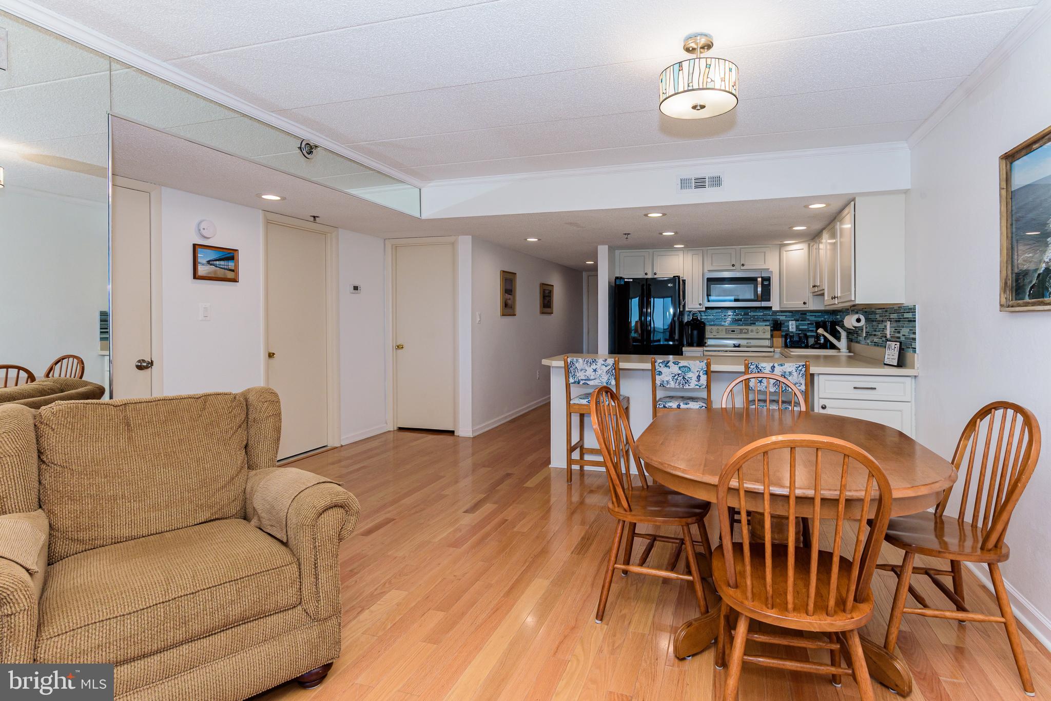 5 77th Street, Unit 102 Ocean City, MD 21842 - Photo 13 of 38 a living room with furniture a dining table and kitchen view