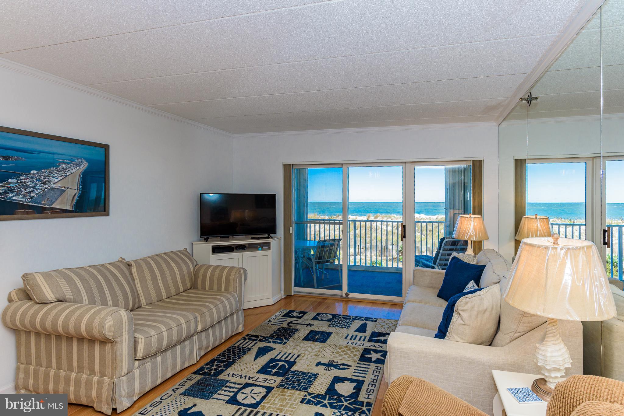 5 77th Street, Unit 102 Ocean City, MD 21842 - Photo 15 of 38 a living room with furniture and a flat screen tv