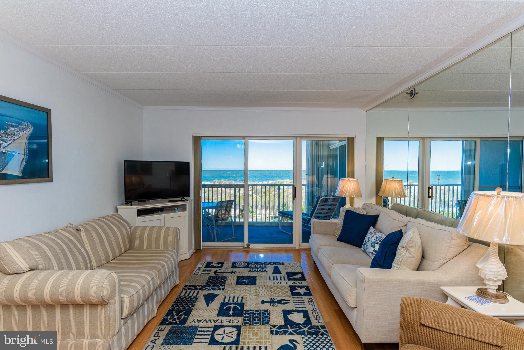 5 77th Street, Unit 102 Ocean City, MD 21842 - Photo 16 of 38 a living room with furniture and a flat screen tv