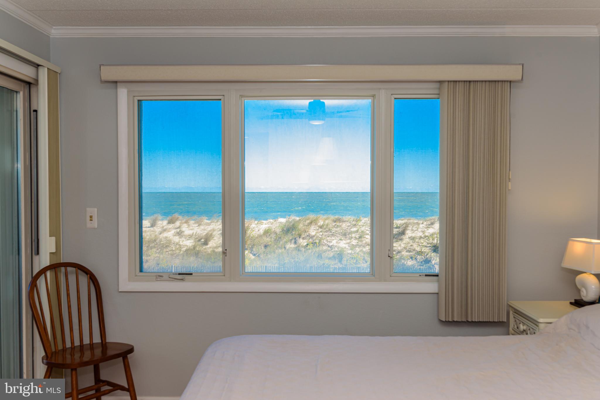 5 77th Street, Unit 102 Ocean City, MD 21842 - Photo 19 of 38 a living room with a chair and a window