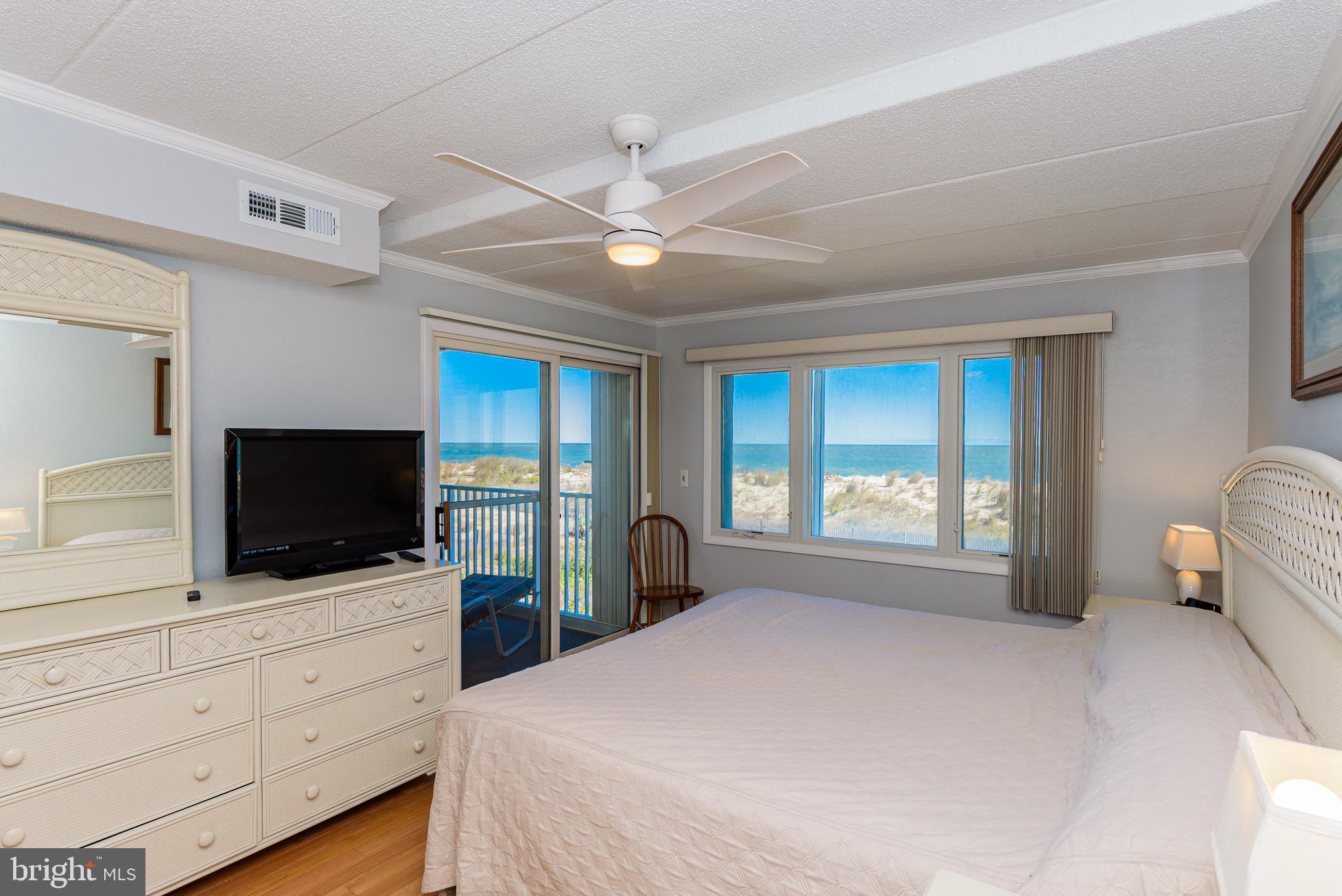 5 77th Street, Unit 102 Ocean City, MD 21842 - Photo 20 of 38 a bedroom with a bed and a flat screen tv