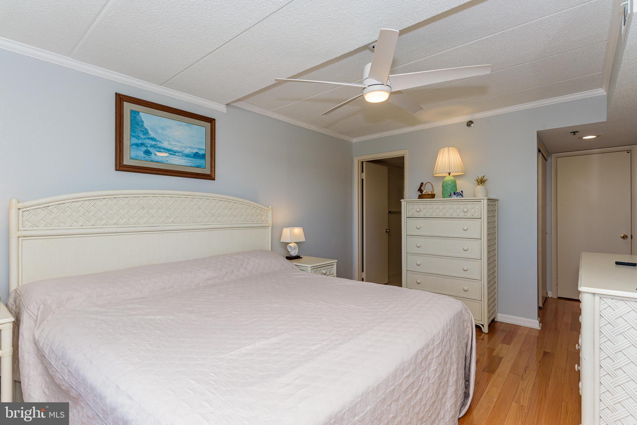 5 77th Street, Unit 102 Ocean City, MD 21842 - Photo 21 of 38 a bedroom with a bed and a dresser