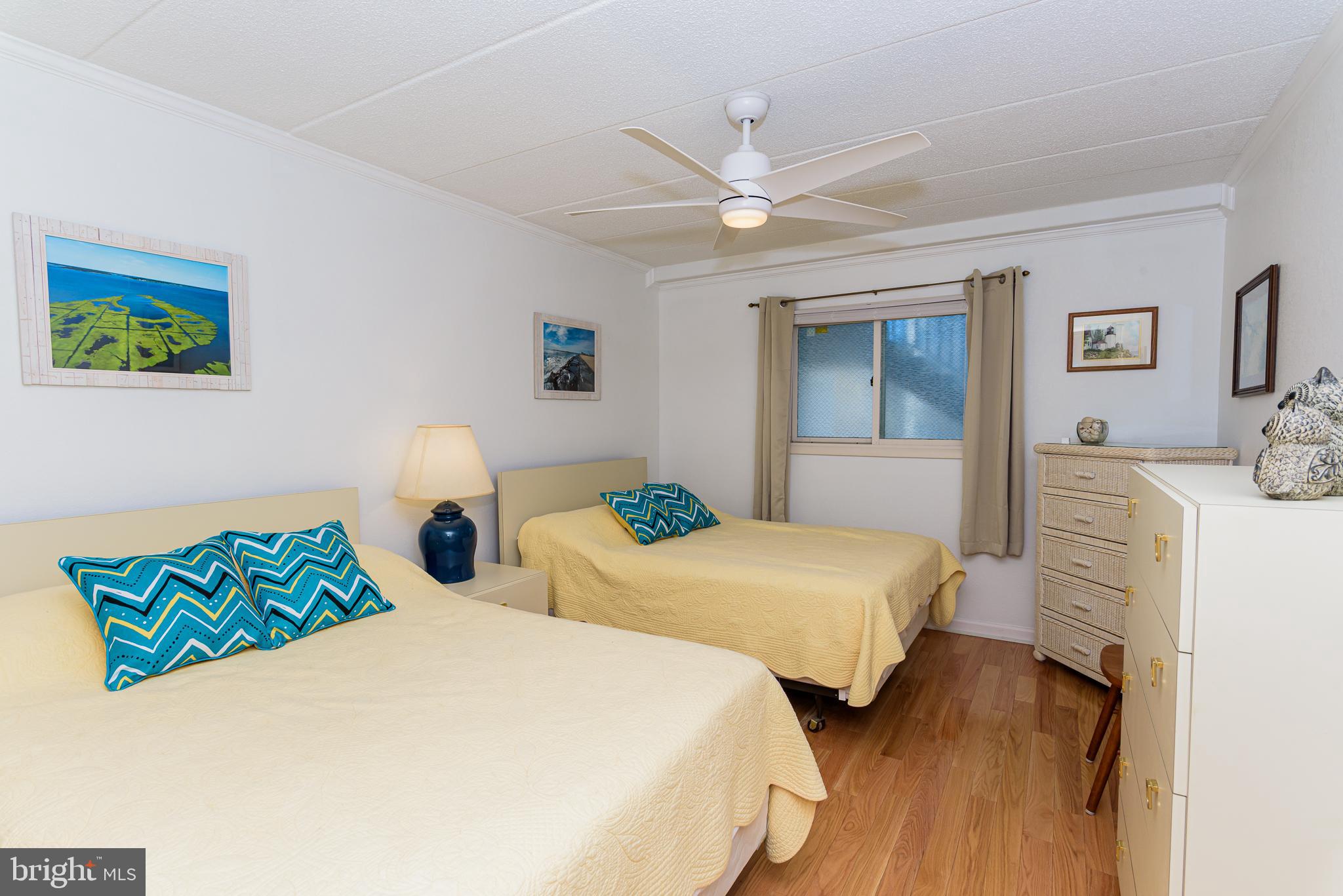 5 77th Street, Unit 102 Ocean City, MD 21842 - Photo 23 of 38 a bedroom with two beds and painting on the wall