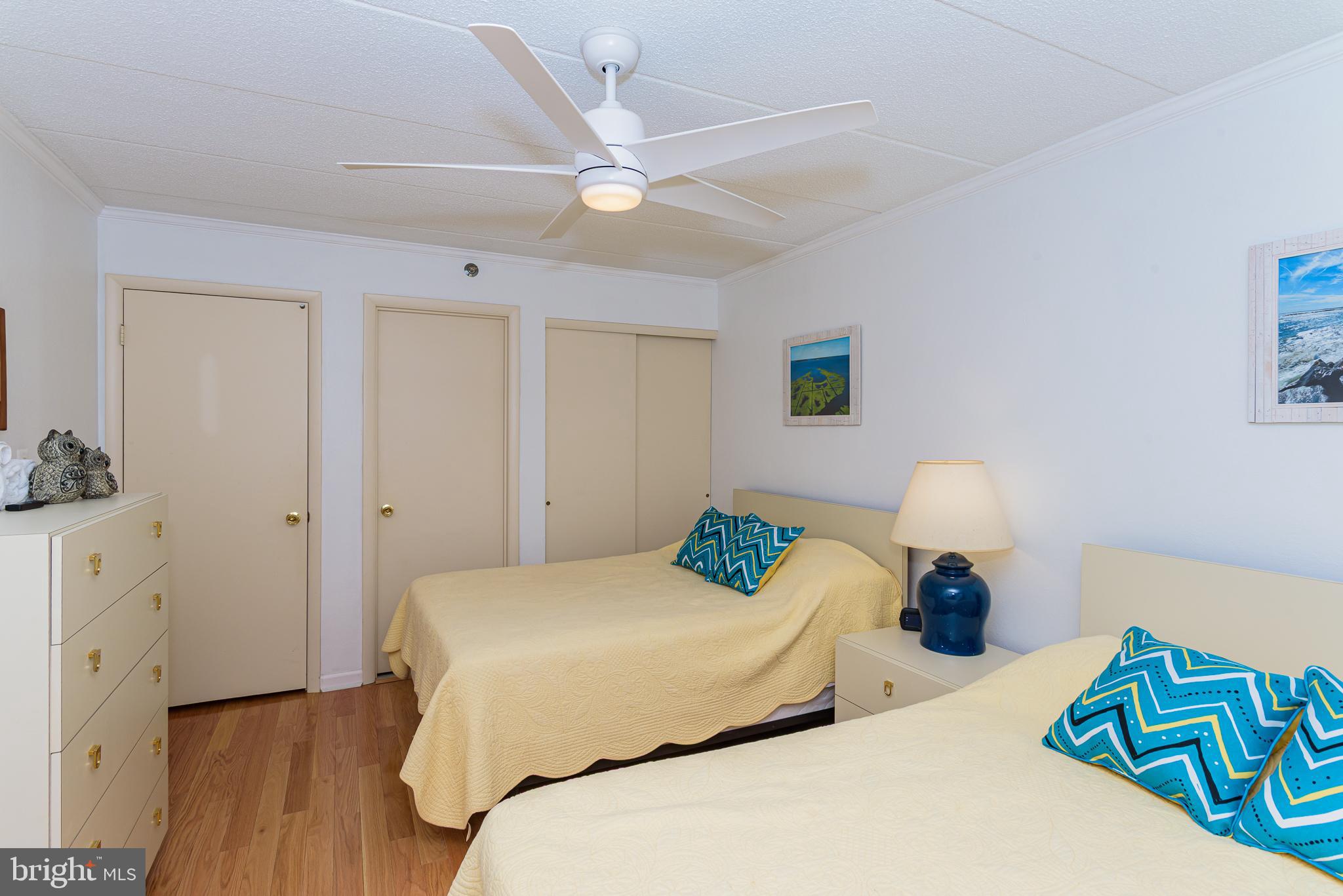 5 77th Street, Unit 102 Ocean City, MD 21842 - Photo 24 of 38 a bedroom with a bed and a dresser