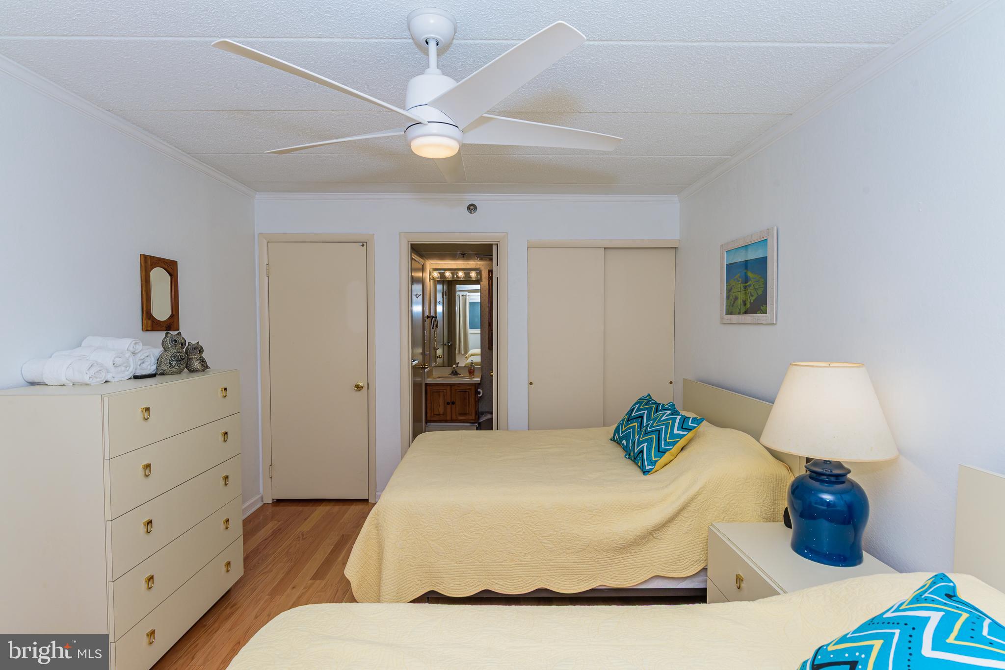 5 77th Street, Unit 102 Ocean City, MD 21842 - Photo 25 of 38 a bedroom with a bed and wooden floor