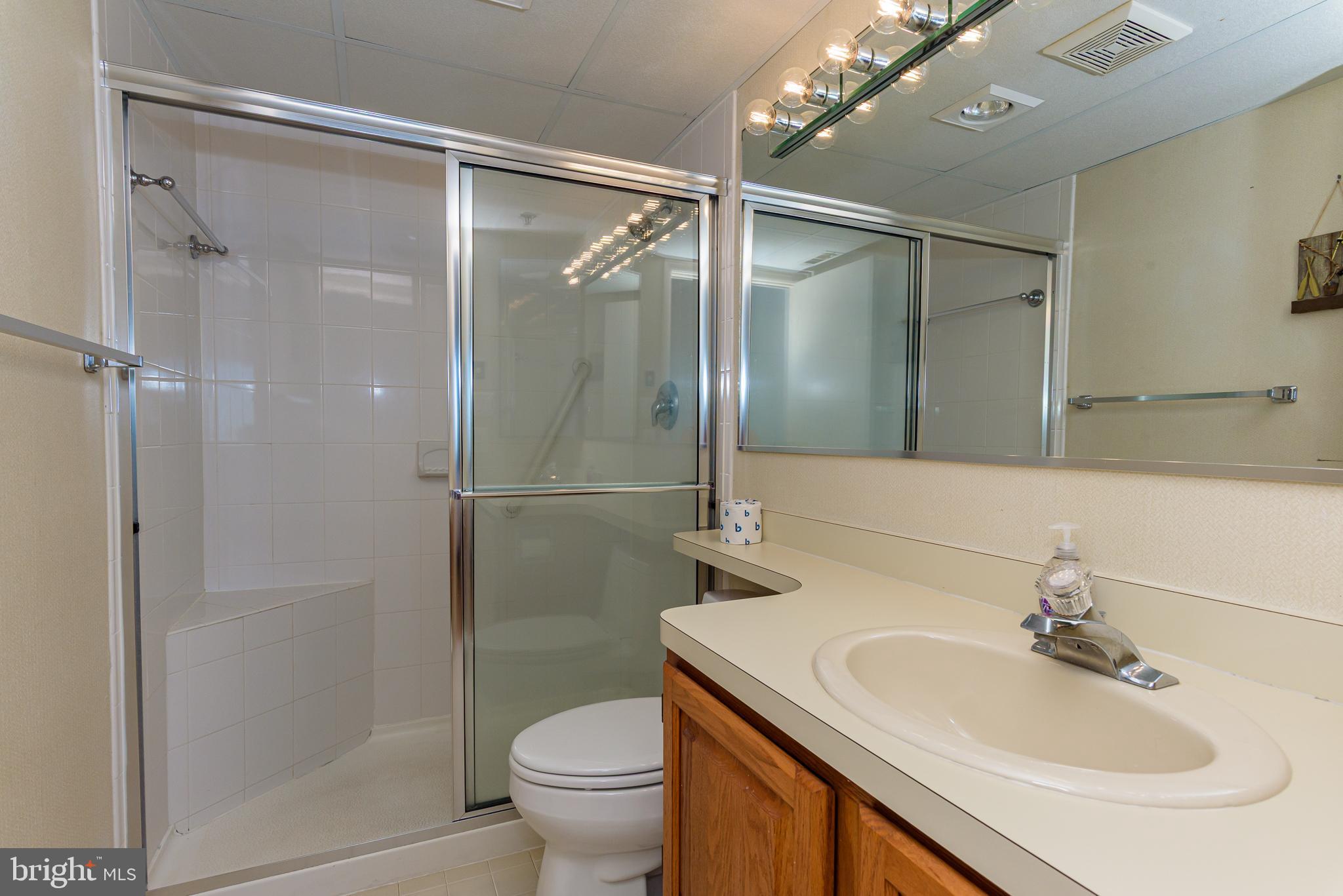 5 77th Street, Unit 102 Ocean City, MD 21842 - Photo 33 of 38 a bathroom with a sink toilet and shower