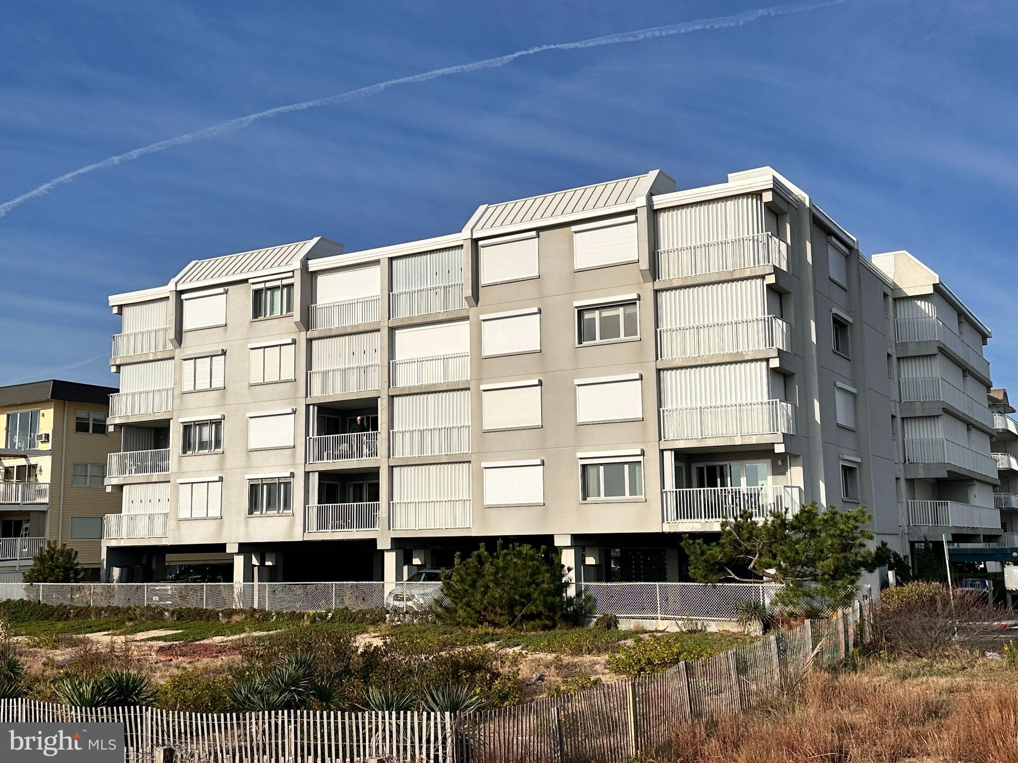 5 77th Street, Unit 102 Ocean City, MD 21842 - Photo 5 of 38 a front view of a building with balcony