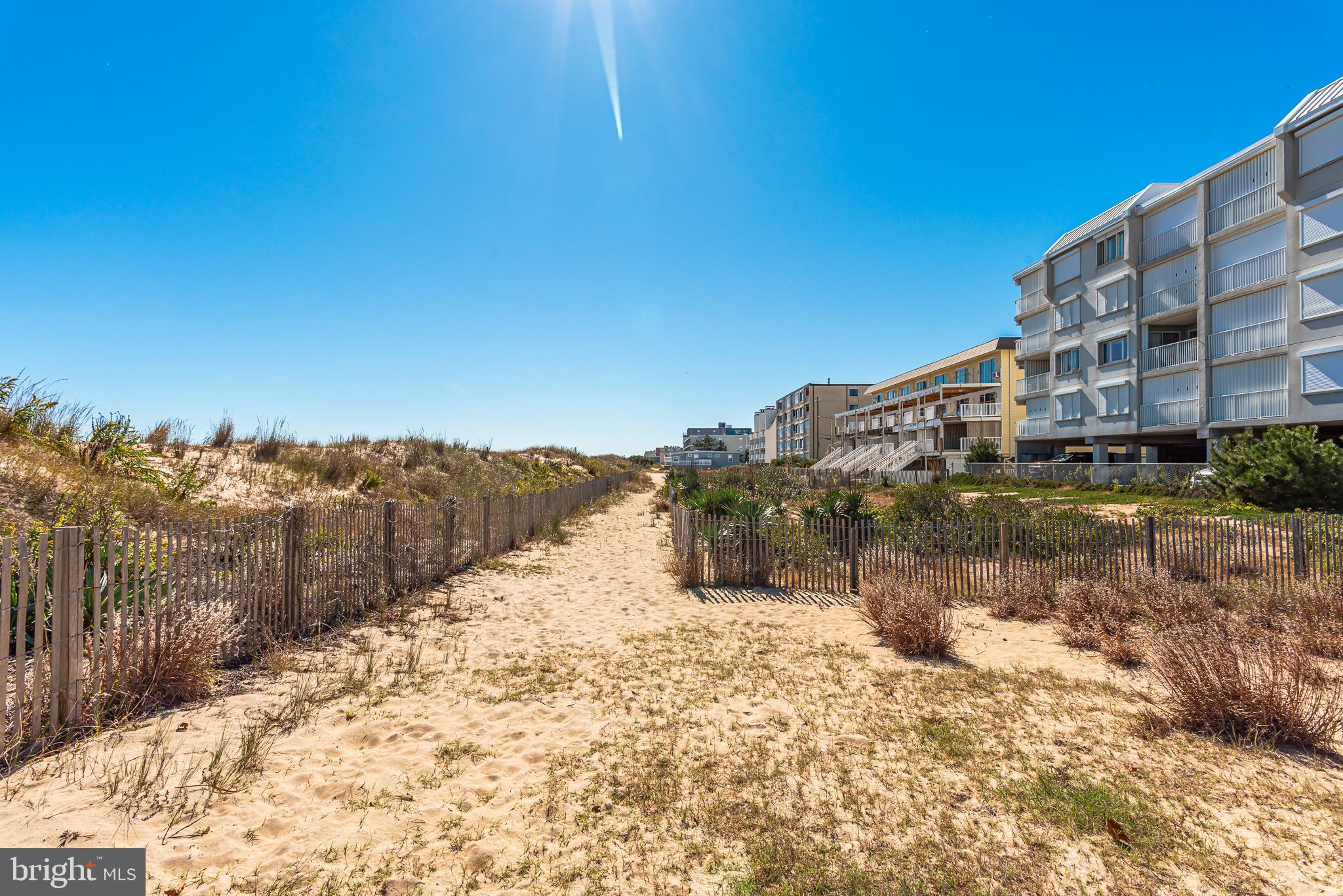 5 77th Street, Unit 102 Ocean City, MD 21842 - Photo 9 of 38 a view of a building with mountains in the background