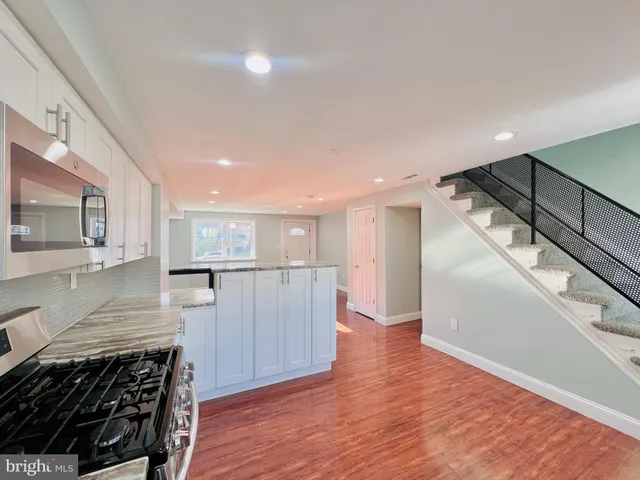 a view of a kitchen with a sink and cabinets