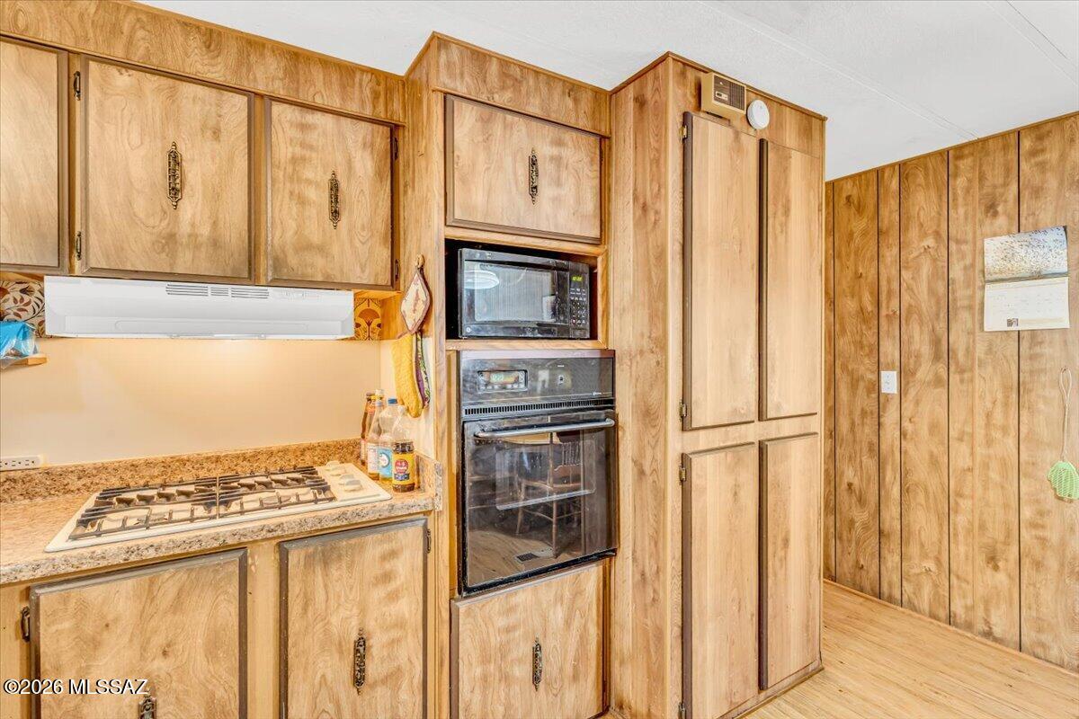5379 West Rafter Cir Street Tucson, AZ 85713 - Photo 6 of 38 a kitchen with stainless steel appliances granite countertop a refrigerator a stove and a sink with wooden floor