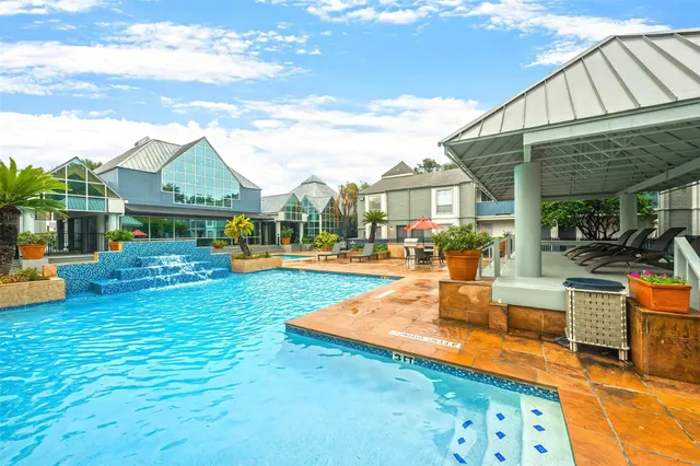 a view of a house with swimming pool and sitting area