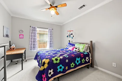 a bedroom with a bed and a desk