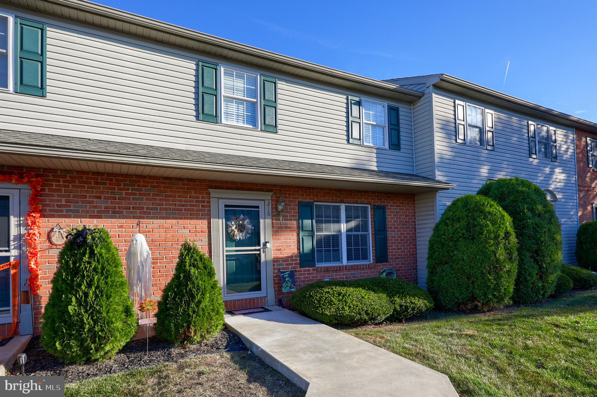 216 Nicole Way Sinking Spring, PA 19608 - Photo 1 of 35 a view of a brick house with plants and a large tree
