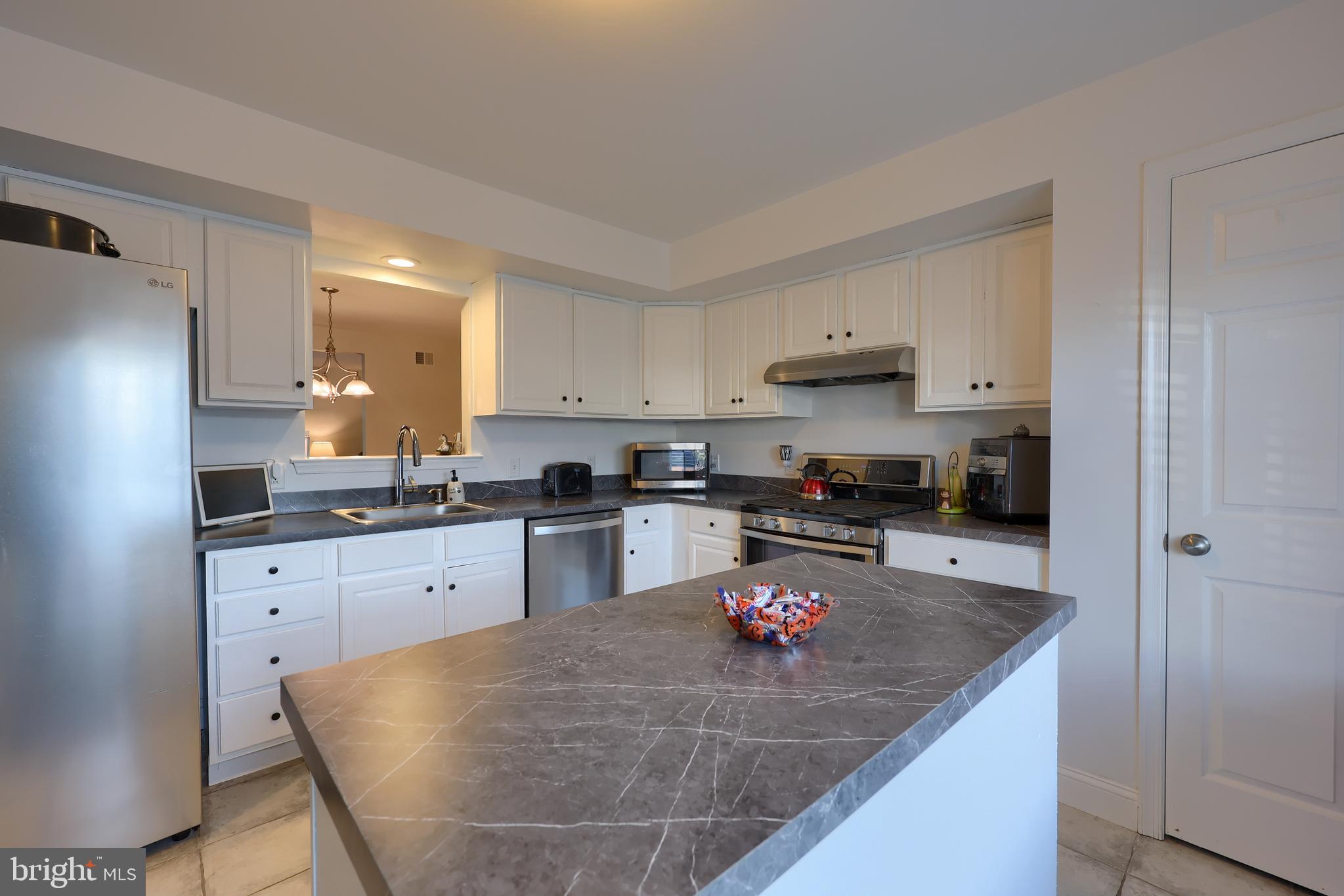 216 Nicole Way Sinking Spring, PA 19608 - Photo 10 of 35 a kitchen with stainless steel appliances granite countertop a sink refrigerator and cabinets
