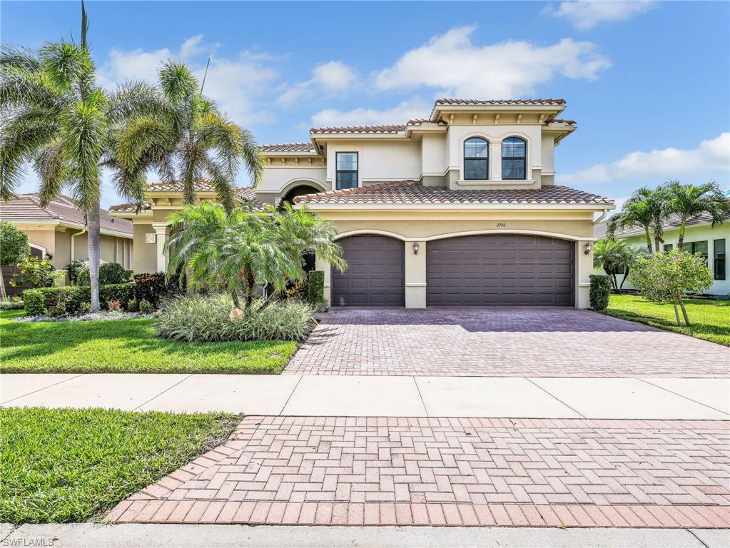 2756 Crystal Way Naples, FL 34119 - Photo 2 of 50 a front view of a house with a garden