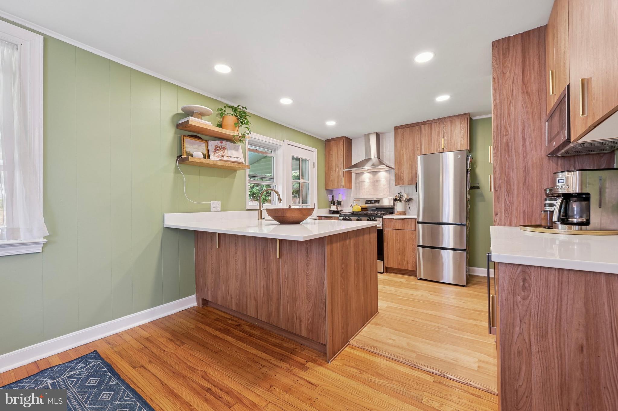 7808 Ridge Avenue Philadelphia, PA 19128 - Photo 5 of 18 a kitchen with stainless steel appliances granite countertop a refrigerator a sink dishwasher and wooden cabinets with wooden floor