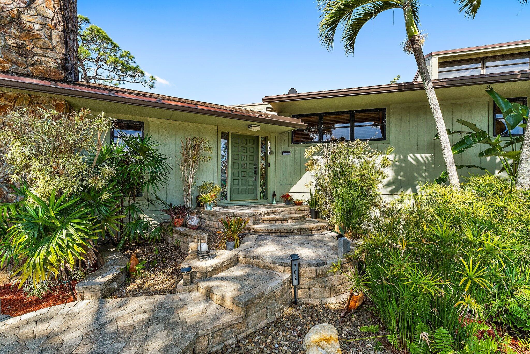 702 Warren Drive Jupiter, FL 33458 - Photo 16 of 76 a view of a house with potted plants