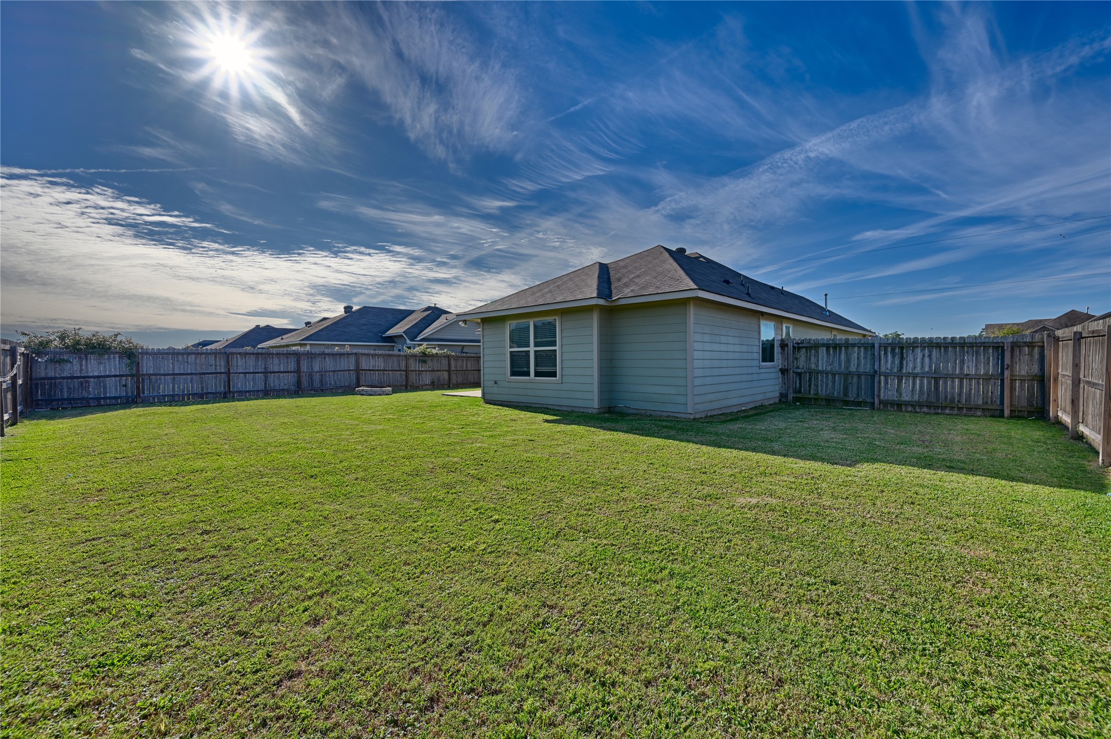 808 Mockingbird Street Navasota, TX 77868 - Photo 19 of 19 a backyard of a house with lots of green space and garden