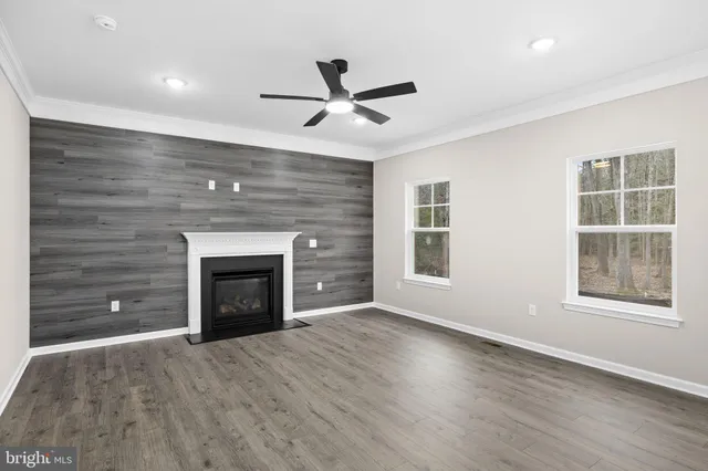 a view of an empty room with a fireplace and a window
