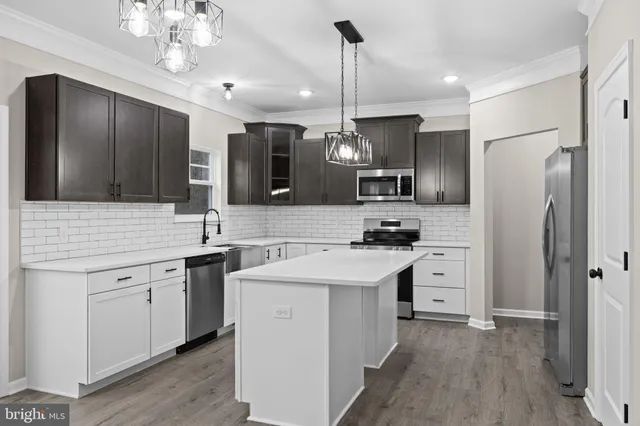 a kitchen with cabinets stainless steel appliances and counter space
