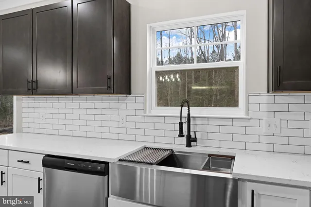 wooden floor fireplace and windows in an empty room