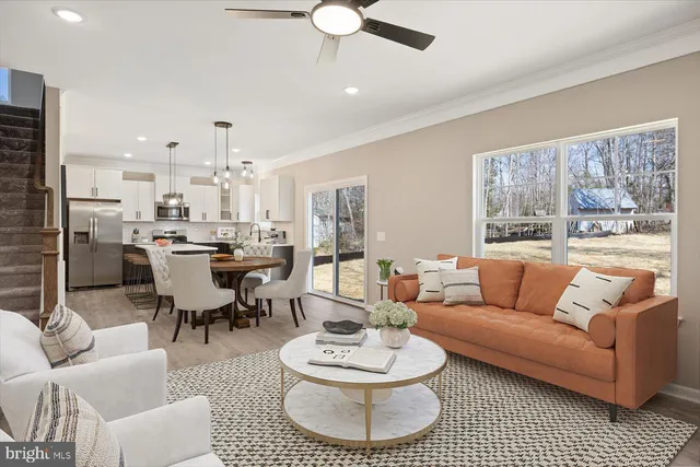a living room with furniture a rug and a chandelier