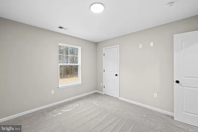 a small white building with a bench