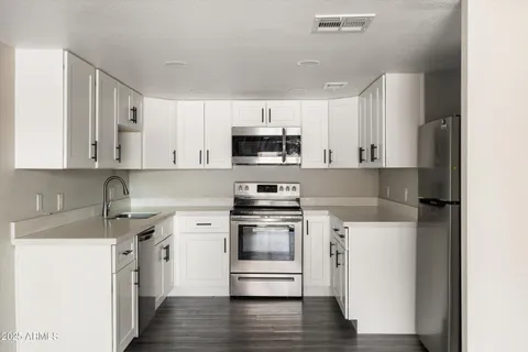 a kitchen with a stove and a microwave