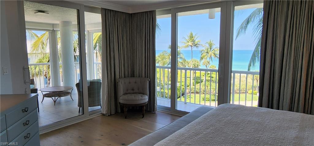 20 Seagate Drive, Unit 301 Naples, FL 34103 - Photo 12 of 29 a view of a bedroom with a bed and a window