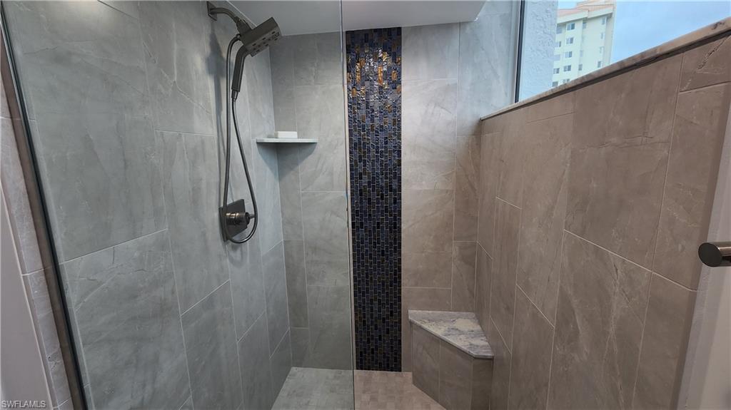 20 Seagate Drive, Unit 301 Naples, FL 34103 - Photo 21 of 29 a bathroom with a granite countertop shower and a toilet