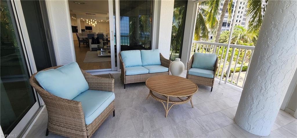 20 Seagate Drive, Unit 301 Naples, FL 34103 - Photo 24 of 29 a living room with furniture and a gate