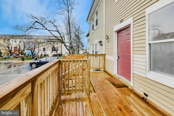 a view of balcony with wooden floor and seating space