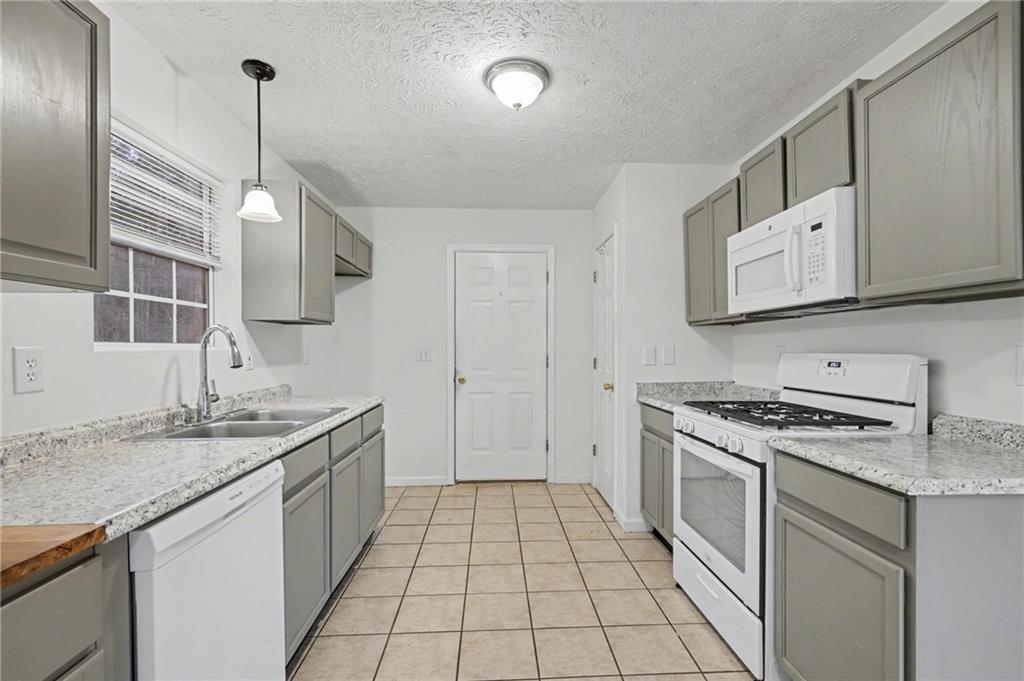 4836 Odessa W Inlet Northwest Acworth, GA 30101 - Photo 11 of 20 a kitchen with a sink stove and cabinets