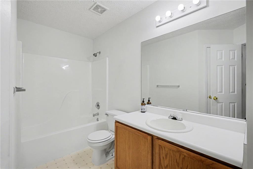 4836 Odessa W Inlet Northwest Acworth, GA 30101 - Photo 18 of 20 a bathroom with a sink a toilet and shower