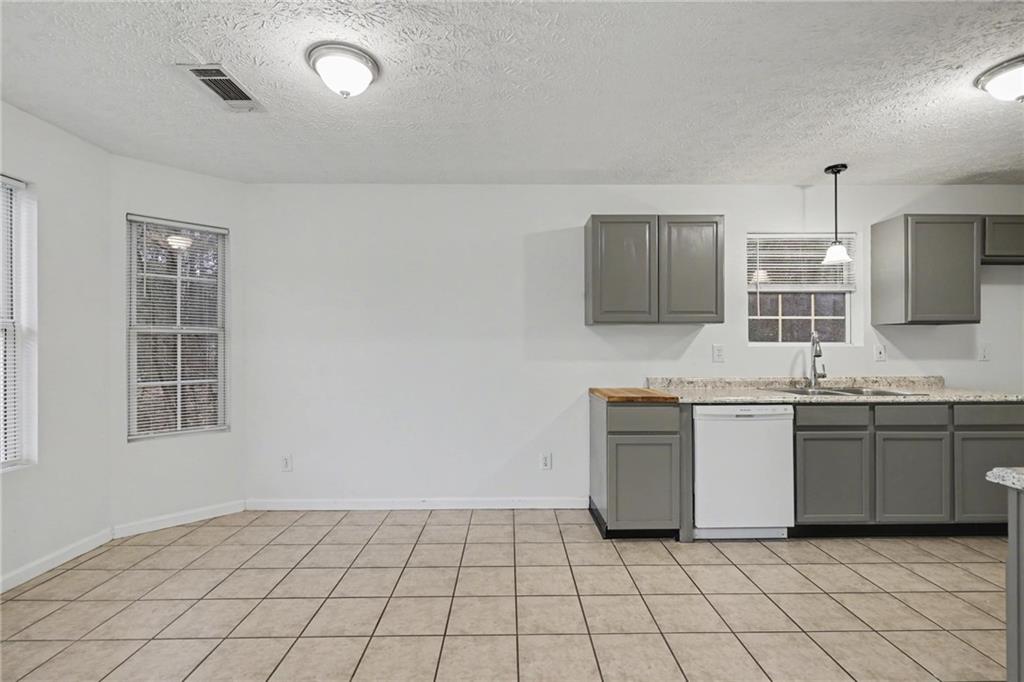 4836 Odessa W Inlet Northwest Acworth, GA 30101 - Photo 7 of 20 a kitchen with granite countertop white cabinets a sink and appliances