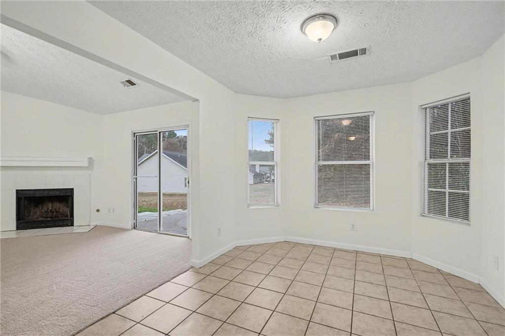 4836 Odessa W Inlet Northwest Acworth, GA 30101 - Photo 8 of 20 a view of an empty room with window and chandelier fan