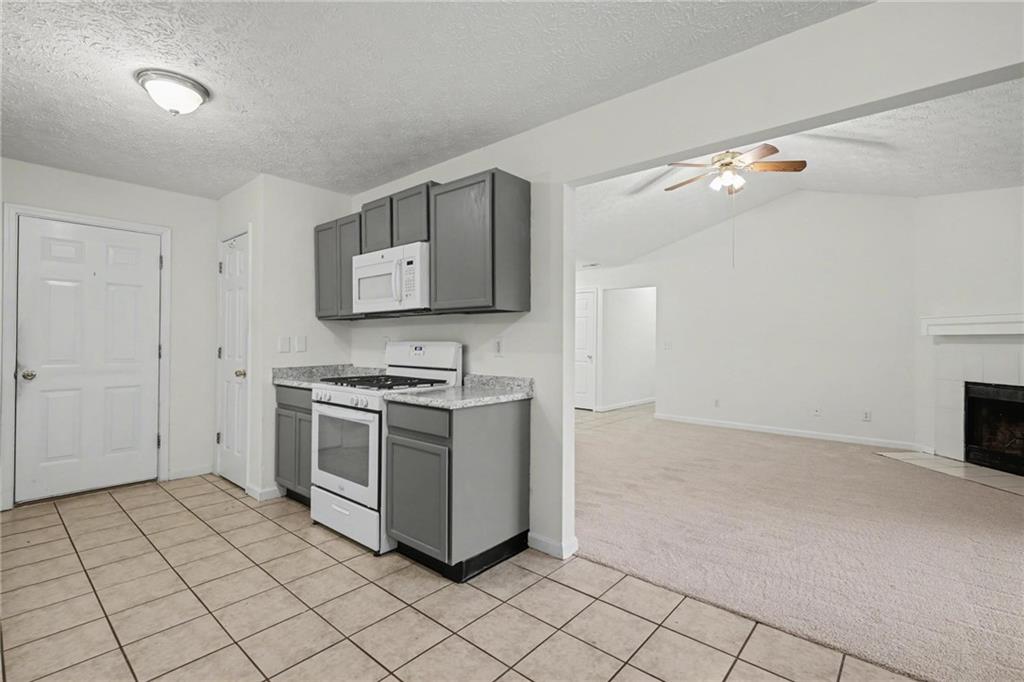 4836 Odessa W Inlet Northwest Acworth, GA 30101 - Photo 10 of 20 a kitchen with a stove and a microwave
