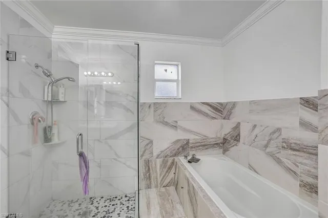 a bathroom with a bathtub and shower