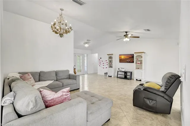 a living room with furniture a couch and a chandelier