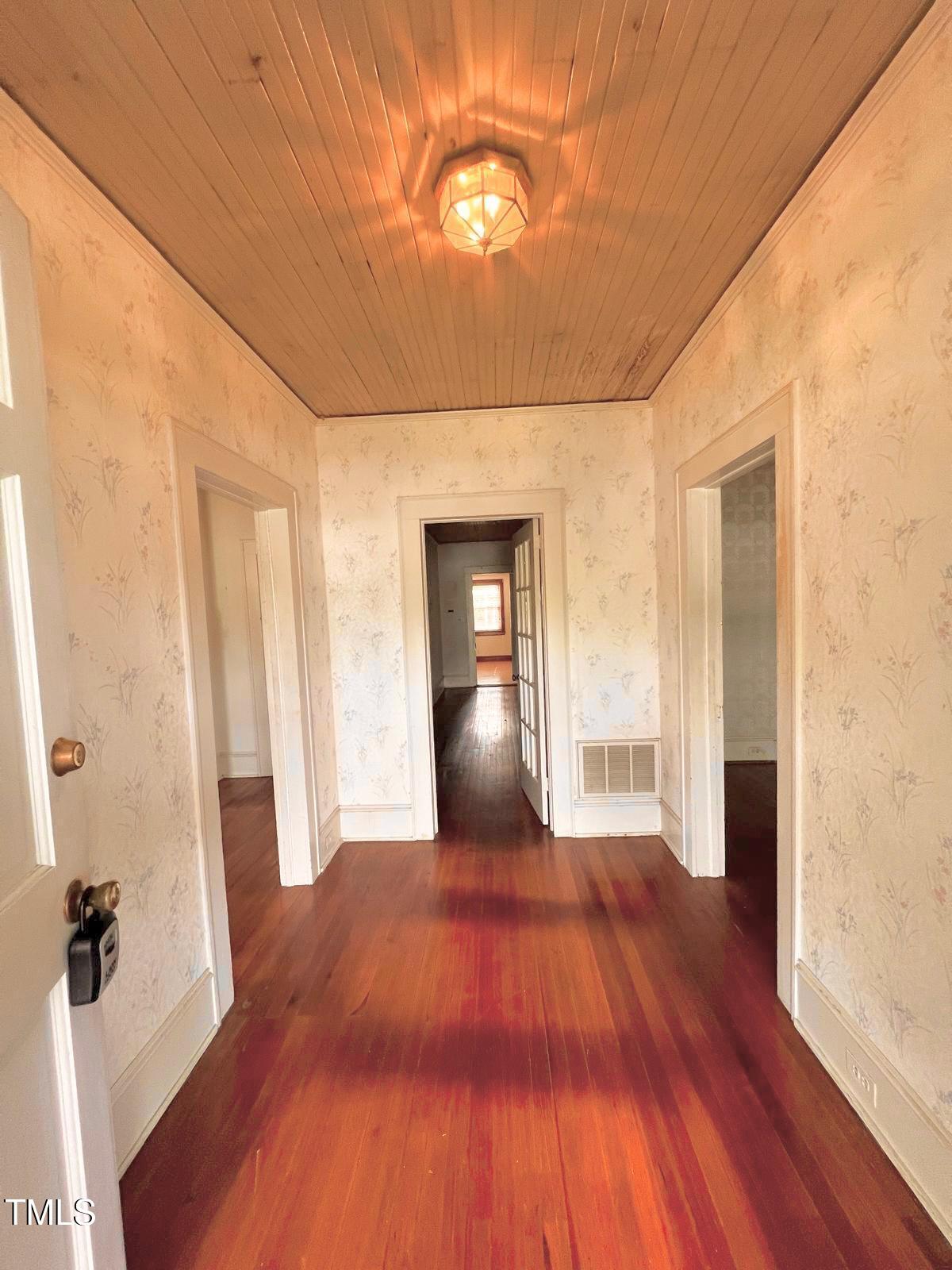310 Spring Street Durham, NC 27703 - Photo 23 of 43 a view of a hallway with wooden floor and staircase