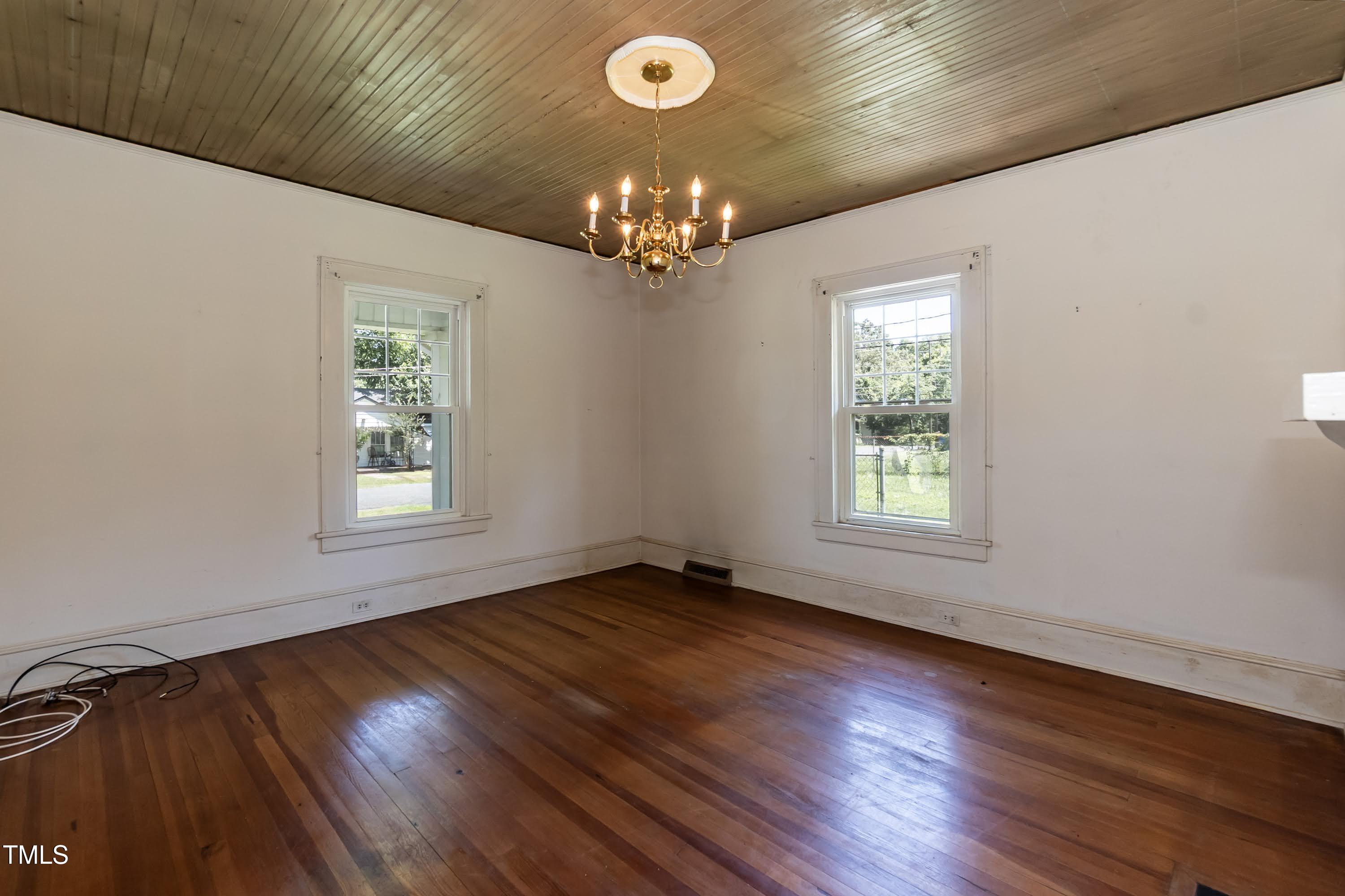 310 Spring Street Durham, NC 27703 - Photo 27 of 43 a view of an empty room with wooden floor and a window